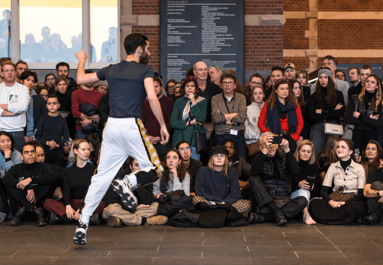 Performer Michele Rizzo doing a dance performance for a big audience.